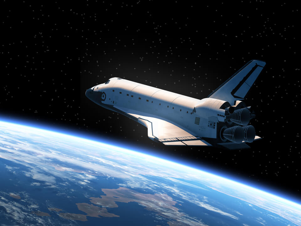 space shuttle flying over Earth
