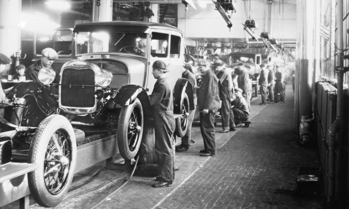 Assembly line workers inside the Ford Motor Company factory at Dearborn, Michigan