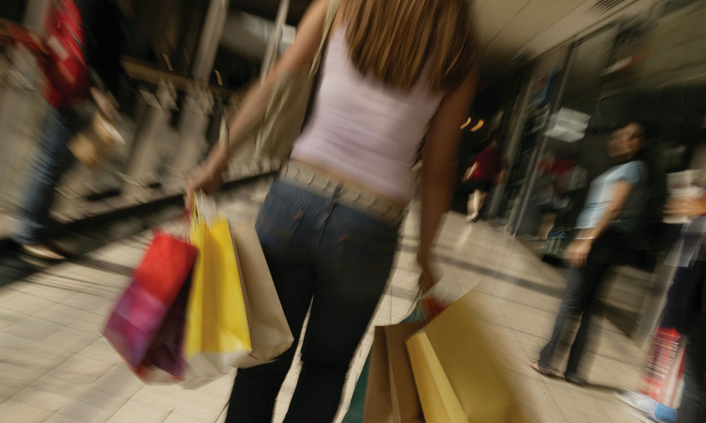 teen carrying shopping bags