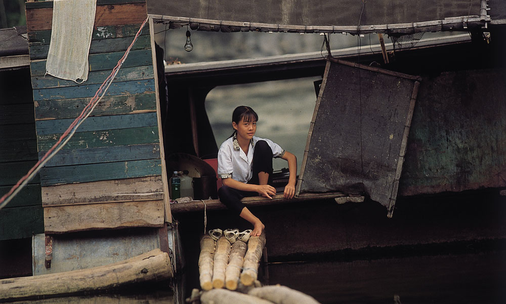 Girl sitting down in a shack in China