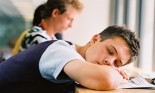 teen boy sleeping at desk