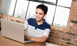 Teenage boy using laptop computer