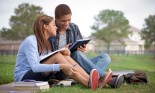 Mixed race couple doing homework with digital tablet