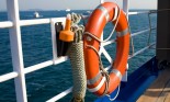 Life belt tied on the railing of a boat, next to automatic floating light, Athens, Greece