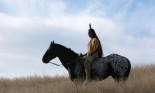 A young Native American Indain horseback riding
