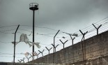 Prison wall with fence and tower