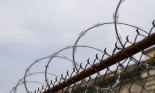 Barbed wire atop chainlink fence