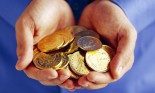 Man's hands holding gold coins