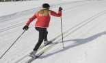 Young woman skiing cross country, rear view