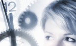 a woman's face looking toward clock gears and numbers