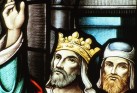 Detail from a stained glass window of two men, one wearing a crown