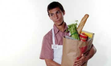 teen boy carrying a bag of groceries teen boy carrying a bag of groceries
