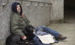 Homeless man with dog and sign