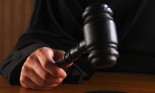 Close-up of a judge's hand banging his gavel