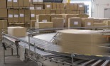 Cardboard boxes on conveyor belt in distribution warehouse