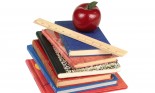 Ruler and apple on stack of books