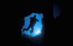 Scuba diver entering an undersea cave