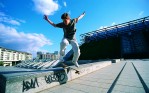 Skateboarder jumping onto a ledge