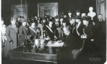 Suffragists gather to see bill signed in to law.
