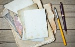 Notebook old papers and pen on a wooden table