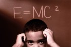 Boy thinking about Albert Einstein's equation