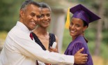 Graduate posing with parents