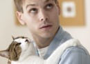 Young man holding his cat