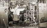 Vintage photo of a man working on a complex machine