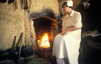 Participant tending fire in historic Jamestown, Virginia, site of the first English Settlement