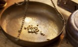 Weighing gold nuggets in an old brass scale dish
