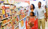 Mother and father with young daughter shopping at the grocery store, San Diego, Calif., USA
