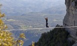 Man practicing highline walking betweein two cliffs in Tavertet, Spain