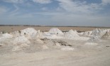 Piles of salt in dry lake bed.