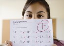 Student holding test with F grade
