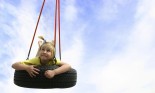 Girl swinging on a tire swing