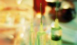 Close up of vaccines in syringes. In the background the rest of laboratory is out of focus.