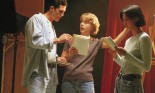 Three actors practicing their lines in a theater