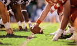 American football game, players at line of scrimmage, close-up