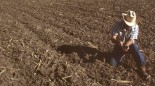 Farmer checking dry soil