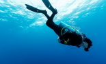 Diver in blue water