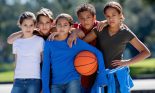 Group of children (10-12 years old) posing with basketball