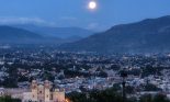 Oaxaca at night: Santo Domingo de Guzmán (lower left) and the city of Oaxaca de Juarez, Oaxaca, Mexico illuminated by the full moon; the mountains of the Sierra Madre del Sur are in the distance