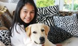 girl sitting with dog