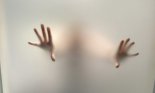 Scary hands behind fogged up glass