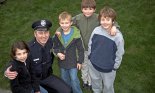 Male police officer smiling with children