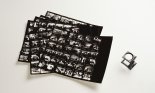 Black and white contact sheet with small magnifying glass for viewing