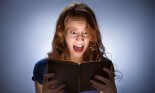 Scared girl screaming while reading book