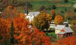 Black-steepled church in autumn