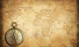 old brass or golden compass with world map background