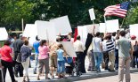 A group of peaceful protestors with banners and posters